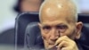 FILE - In this photo released by the Extraordinary Chambers in the Courts of Cambodia, Nuon Chea, who was the Khmer Rouge's chief ideologist and No. 2 leader, sits in a courtroom before a hearing at the U.N.-backed war crimes tribunal in Phnom Penh.