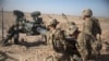 FILE - photo provided by Operation Resolute Support, U.S. Soldiers with Task Force Iron maneuver an M-777 howitzer, so it can be towed into position at Bost Airfield, Afghanistan.