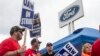 (FILES) Members of the United Auto Workers (UAW) pickett outside of the Michigan Parts Assembly Plant in Wayne, Michigan, on September 26, 2023.
