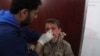 This photo provided by the Syrian anti-government activist group Ghouta Media Center, which has been authenticated based on its contents and other AP reporting, shows a Syrian doctor treating a boy who was wounded by Syrian government forces shelling, at a makeshift hospital in the Hamouriyya neighborhood, an eastern suburb of Damascus, Syria, May 16, 2017. 