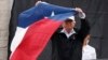 President Donald Trump holds up a Texas flag after speaking with supporters outside Firehouse 5 in Corpus Christi, Texas, Aug. 29, 2017, where he received a briefing on Harvey relief efforts.