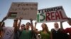 Lebanese and Palestinians hold up placards during a protest against the war in Gaza, in Beirut, Lebanon, July 21, 2014. 