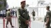 A Tunisian army officer stands guard outside the Bouchoucha military base after shooting in Tunis, Tunisia, May 25, 2015. 