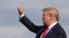 President Donald Trump gestures as he disembarks Air Force One upon arrival at Wheeling, West Virginia, July 24, 2019. 