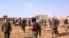 Soldiers attend to wounded and casualties in the aftermath of a suicide bomb attack who ripped through a camp grouping former rebels and pro-government militia in troubled northern Mali Jan. 18, 2017 in Gao. 