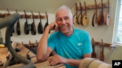 Mike Dulak sits for a portrait in his mandolin workshop in Rocheport, Mo., Friday, Sept. 8, 2023. Dulak does not associate with any religious group and self-identifies as "nothing in particular" when asked about his beliefs.
