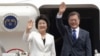 South Korean President Moon Jae-in and his wife, Kim Jung-sook, wave before leaving for the United States at the Seoul military airport in Seongnam, South Korea, June 28, 2017. Moon left for the United States for a summit meeting with his U.S. counterpart