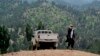 FILE - A Taliban militant is seen walking in Pakistan's tribal region of North Waziristan. Aug. 12, 2013. American author Paul Overby was hoping to reach to the region when he went missing in May 2014.