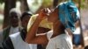 FILE - A woman takes the first dose of oral vaccine against cholera during an epidemic in Tougnifili, Guinea. (Courtesy David Di Lorenzo/MSF)