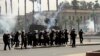 Riot police fire tear gas towards supporters of the Muslim Brotherhood during a demonstration at Cairo University, Egypt, May 20, 2014.