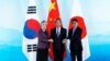 左起：韩国外长康京和、中国外长王毅和日本外相河野太郎在北京举行的中日韩三国外长会议上握手。（2019年8月21日））