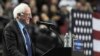 Democratic presidential candidate Bernie Sanders smiles as a bird lands on his podium during a campaign speech in Portland, Oregon, March 25, 2016.