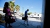 FILE - Parkinson's patient Ron Addison (R) makes his way home after working out with trainer Anne Adams following their twice-weekly Rock Steady Boxing class in Costa Mesa, California.