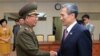 South Korean presidential security adviser Kim Kwan-jin, right, shakes hands with Hwang Pyong So, North Korea's top political officer for the Korean People's Army, after meeting at the border village of Panmunjom in Paju, South Korea, Aug. 25, 2015. 