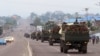 FILE - Military trucks carrying Congolese troops drive down a main street after violence erupted due to the delay of presidential elections, in Kinshasa, Democratic Republic of Congo, Sept. 20, 2016.