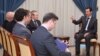 FILE - A handout picture shows Syrian President Bashar al-Assad (R) meeting with Russia’s Special Envoy Azmatullah Kolmohammadov (6L) and accompanying delegation, released on March 22, 2015 by Syrian Arab News Agency (SANA).