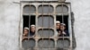Afghan students from a religious school look on from a window of their school in Kabul, Afghanistan, Oct. 5, 2016.