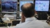 A trader looks at his screens during a bond auction on a trading floor in Madrid, June 7, 2012. 