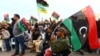 FILE - Libyan protesters take part in a rally in support of "Fajr Libya" (Libya Dawn), a mainly Islamist alliance, in Tripoli's central Martyr's Square, Feb. 13, 2015.