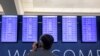 Passengers wait for the flights to resume at Hartsfield-Jackson Atlanta International Airport in Atlanta