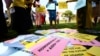 FILE - Supporters of the anti-gay law prepare for a procession backing the signing of the anti-gay bill into law, in Uganda's capital, Kampala.