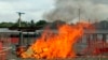 A portion of a Medecins Sans Frontieres (MSF) Ebola treatment unit burns as the MSF begins decommissioning the facility in Monrovia, Liberia, Jan. 26, 2015.
