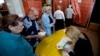 People wait in line at a polling station in the center of Slovyansk, eastern Ukraine, May 11, 2014. 