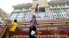 People walk in front of the Phnom Penh Municipal Court before a verdict against six union leaders, in Phnom Penh, Cambodia, Dec. 11, 2018. 