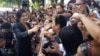 FILE - Ousted former Thai Prime Minister Yingluck Shinawatra greets supporters as she leaves the Supreme Court in Bangkok, Thailand, Aug. 1, 2017. 
