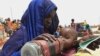 FILE - A mother quenches her malnourished child's thirst while waiting for food handouts at a health center in drought-stricken remote Somali region of Eastern Ethiopia, also known as the Ogaden, July 2011.