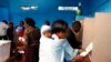 A woman with a child casts her ballot inside a polling station in Kenya's town of Gatundu March 4, 2013. Polling stations opened up to Kenyans on Monday for a tense presidential election that will test whether the east African nation can repair its damage