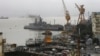 Ships ride at anchors at a naval dockyard where a submarine caught fire and sank after an explosion early Wednesday in Mumbai, August 14, 2013. 