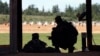 FILE - A U.S. Army recruit is instructed by a drill sergeant, right, during live-fire marksmanship training at Fort Jackson, S.C., Aug. 17, 2016.