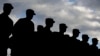 FILE - US soldiers stand in formation during a military ceremony at the Storck barracks in Illesheim, Germany.