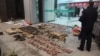 In this Jan. 9, 2020, photo provided by the Anti-Poaching Special Squad, police look at items seized from store suspected of trafficking wildlife in Guangde city in central China's Anhui Province.