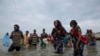 FILE - Ethiopian migrants disembark from a boat onto the shores of Ras al-Ara, Lahj, Yemen, July 26, 2019.