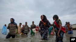 FILE - Ethiopian migrants disembark from a boat onto the shores of Ras al-Ara, Lahj, Yemen, July 26, 2019.