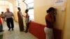 FILE - An Eritrean would-be immigrant talks on the phone at the Lyster barracks detention center for immigrants in Hal Far, outside Valletta, Malta.