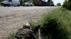 A pro-Russian rebel takes his position at a front line rebel position near the eastern Ukrainian town of Slovyansk May 16, 2014. 