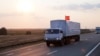 A convoy of white trucks carrying humanitarian aid passes along the main road M4 (Don highway) Voronezh region, Russia, Aug. 12, 2014