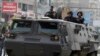 Riot police look from their armoured personnel vehicle during clashes with supporters of Muslim Brotherhood and ousted Egyptian President Mohamed Mursi at Nasr City district in Cairo, Jan. 3, 2014. (Reuters)