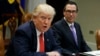 FILE - Treasury Secretary Steven Mnuchin listens at right as President Donald Trump speaks during a meeting on the Federal budget, Feb. 22, 2017, in the Roosevelt Room of the White House in Washington.