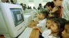 Visitors watch as Cambodian orphans learn computer skills and exploring the Internet world during the opening ceremony at the Future Light Orphanage on the outskirt of Phnom Penh, Cambodia, file photo. 