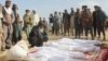 FILE - Afghan villagers gather around several victims of clashes between Taliban and Afghan security forces in the Taliban-controlled, Buz-e Kandahari village in Kunduz province, Afghanistan, Nov. 4, 2016. 