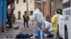 Health workers disinfect the body of a street vendor who was found dead by his neighbors in the Cerro San Miguel neighborhood of Cochabamba, Bolivia, July 25, 2020.