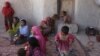 In this May 30, 2016, photo, members of an internally displaced Afghan family are seen at their temporary home in a camp for displaced people in Kabul, Afghanistan.