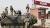FILE -Turkish military station at the border gate with Syria, across from Syrian rebel-controlled Tel Abyad town, in Akcakale, Turkey, October 7, 2012.