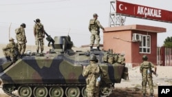 FILE -Turkish military station at the border gate with Syria, across from Syrian rebel-controlled Tel Abyad town, in Akcakale, Turkey, October 7, 2012.