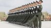 Soldiers of China's People's Liberation Army march with their weapons during a training session for a military parade to mark the 70th anniversary of the end of World War II, at a military base in Beijing, Sept. 1, 2015. 