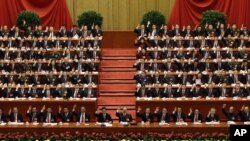 China's leaders raise their hands to show approval for a work report at the closing ceremony for the 18th Communist Party Congress, Beijing, November 14, 2012.